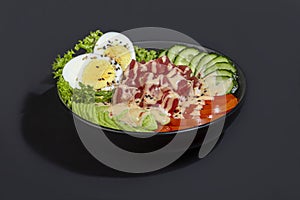 Salad bowl with tuna rice, tomatoes, cucumbers and avocado. Boiled egg.