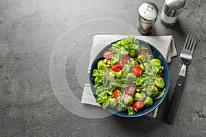 Salad with Brussels sprouts served on grey table, flat lay.