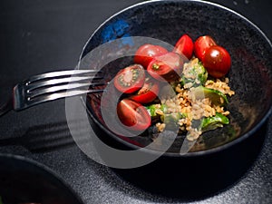 Salad with bulgur and vegetables, tomatoes and Brussels sprouts.
