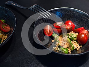 Salad with bulgur and vegetables, tomatoes and Brussels sprouts.