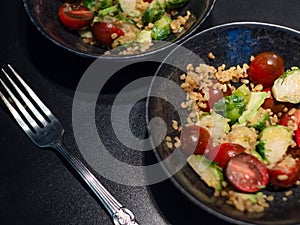 Salad with bulgur and vegetables, tomatoes and Brussels sprouts.