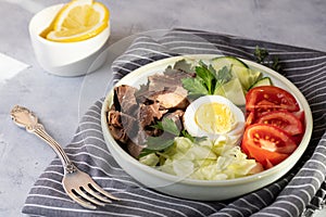 Salad with canned tuna, egg and vegetables - tomatoes, cucumber and lettuce