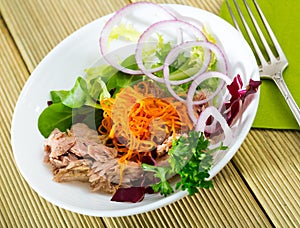 Salad of carrots with canned tuna, onion