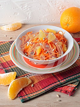 Salad of carrots with orange slices and sunflower seeds