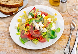 Salad with cheese, tomato, peppers, and corn