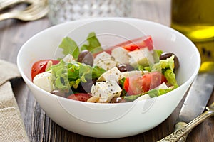 Salad cheese with vegetables in white bowl