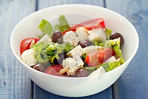 Salad cheese with vegetables in white dish