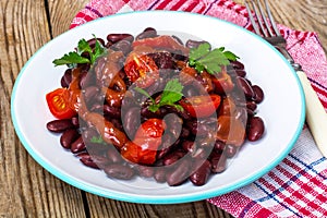 Salad with cherry tomatoes and red beans in spicy tomato sauce