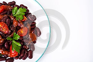 Salad with cherry tomatoes and red beans in spicy tomato sauce