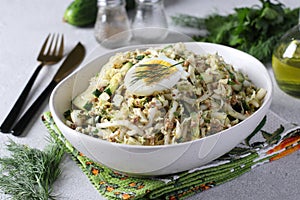 Salad with Chinese cabbage, tuna and cucumber, garnished with half an egg