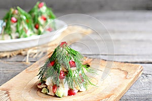 Salad Christmas tree. Salad with meat, mushrooms, cucumbers and eggs decorated with dill. Christmas recipe. Old wooden background