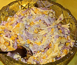 Salad consists of pineapples, cheese, ham, corn, mayonnaise.