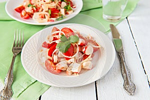 Salad from crabmeat sticks and tomatoes