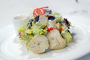 Salad with a crude and artichokes photo