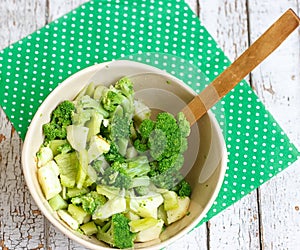 Salad in a deep bowl, broccoli, pepper and apple