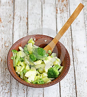 Salad in a deep bowl, broccoli, pepper and apple
