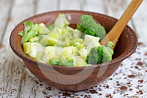 Salad in a deep bowl, broccoli, pepper and apple