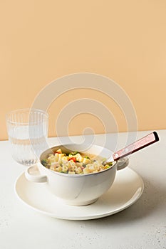 Salad with ditalini pasta, peas, vegan sausage on modern white table. Close up.