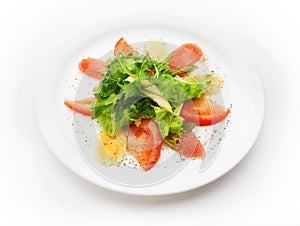 Salad from fish meat, tomato, and salad leafs on white background