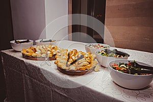Salad and Fresh Bread Rolls on Catering Table