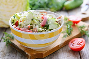 Salad from fresh cabbage, cucumbers and cherry tomatoes