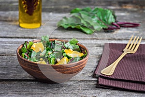 Salad of fresh chard and orange with pine nuts