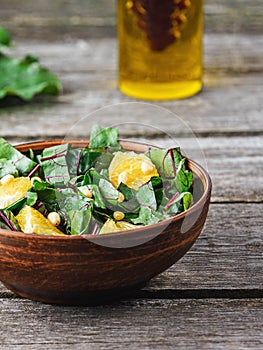 Salad of fresh chard and orange with pine nuts