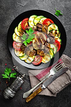 Salad with fresh and grilled vegetables and mushrooms. Vegetable salad with grilled champignons. Vegetable salad