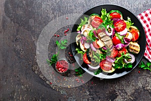 Salad with fresh and grilled vegetables and mushrooms. Vegetable salad with grilled champignons. Vegetable salad on plate