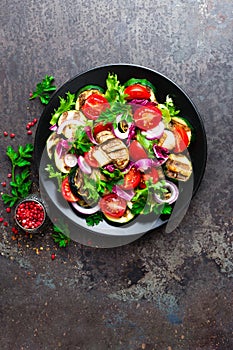 Salad with fresh and grilled vegetables and mushrooms. Vegetable salad with grilled champignons. Vegetable salad on plate