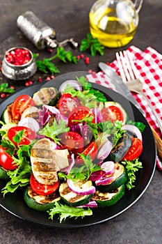 Salad with fresh and grilled vegetables and mushrooms. Vegetable salad with grilled champignons. Vegetable salad on plate