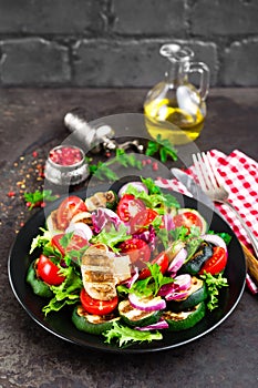 Salad with fresh and grilled vegetables and mushrooms. Vegetable salad with grilled champignons. Vegetable salad on plate