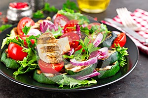 Salad with fresh and grilled vegetables and mushrooms. Vegetable salad with grilled champignons. Vegetable salad on plate