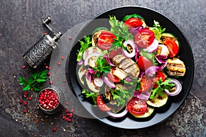 Salad with fresh and grilled vegetables and mushrooms. Vegetable salad with grilled champignons. Vegetable salad on plate