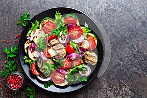 Salad with fresh and grilled vegetables and mushrooms. Vegetable salad with grilled champignons. Vegetable salad on plate