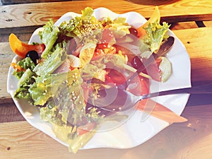 Salad. Fresh summer lettuce salad.Healthy mediterranean salad on wooden table. Vegetarian food.