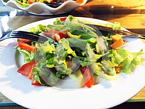 Salad. Fresh summer lettuce salad.Healthy mediterranean salad on wooden table. Vegetarian food