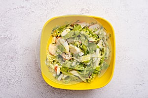 salad of fresh vegetables and crab sticks in a plastic container. The concept of healthy eating