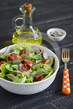 Salad with fresh vegetables, garden herbs and sun-dried tomatoes