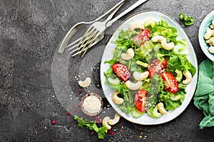 Salad with fresh vegetables and nuts. Vegetable salad with fresh vegetables and cashew. Vegetable salad on plate