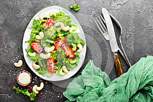 Salad with fresh vegetables and nuts. Vegetable salad with fresh vegetables and cashew. Vegetable salad on plate