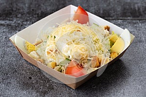 Salad of fresh vegetables from tomatoes, cucumbers, olives and pineapples. salad with mayonnaise and cheese