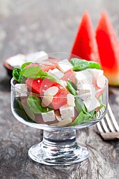 Salad with fresh watermelon and feta with basil and spinach lea