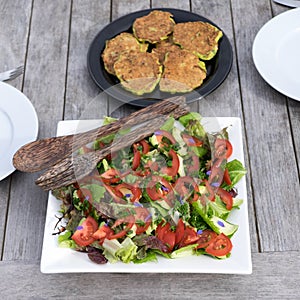 Salad and fritters outdoors