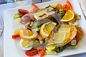 Salad from goat cheese with honey and orrange at plate, french cuisine