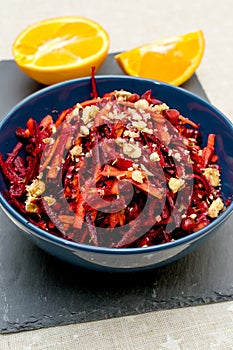 Salad of grated red beets carrots pomegranates and walnuts