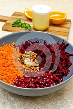 Salad of grated red beets carrots pomegranates and walnuts