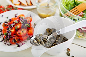 Salad with grilled meat, smoked fish and different vegetables.