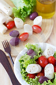 Salad of heart of palm (palmito), cherry tomatos, hydroponic, olives