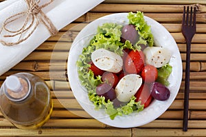 Salad of heart of palm (palmito), cherry tomatos, olives, pepper